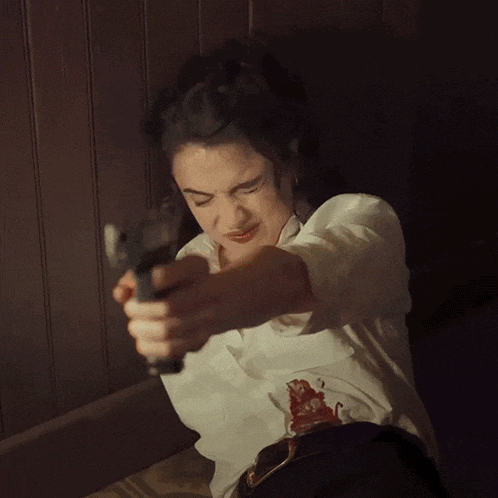 a woman in a white shirt is holding a torch in her hand
