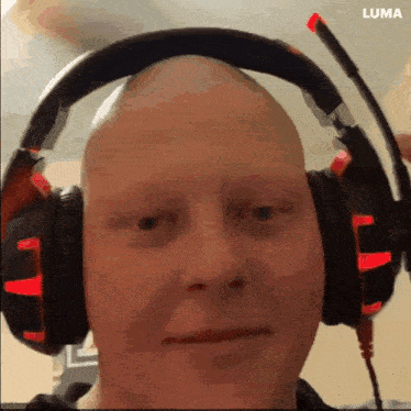 a close up of a man wearing headphones with a luma logo behind him
