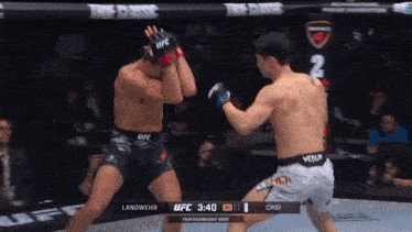 two men are fighting in a boxing ring and one of them is wearing a ufc glove