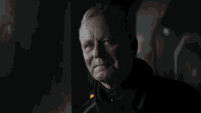 a man in a dark room says " everything " at the bottom