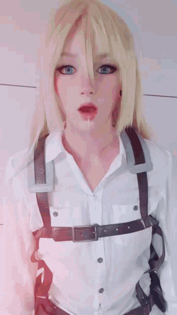 a woman with blonde hair is wearing a white shirt