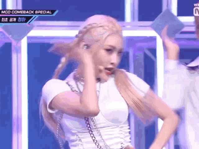 a woman in a white top is dancing on a stage with the words mcd comeback special on the bottom right