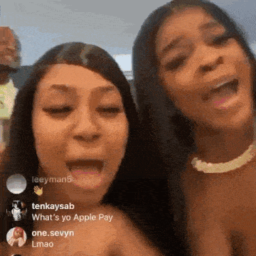 two women are standing next to each other with their mouths open and their tongues out .