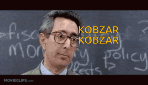 a man is standing in front of a blackboard with the name kobzar written on it