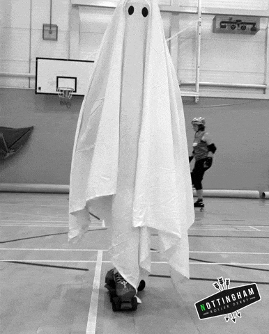 a person in a ghost costume is rollerblading in a gym with a nottingham roller derby logo