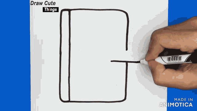 a person is drawing a book with a marker on a piece of paper that says draw cute things on it