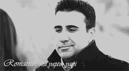 a black and white photo of a man with the words romantik just yaptim papi written on the bottom