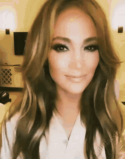 a close up of a woman 's face with a watermark that says ' jlotime.com ' at the bottom