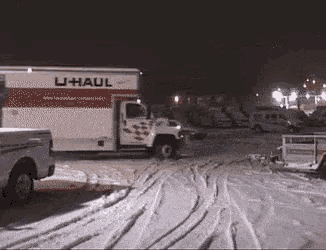 a u-haul truck is parked in the snow