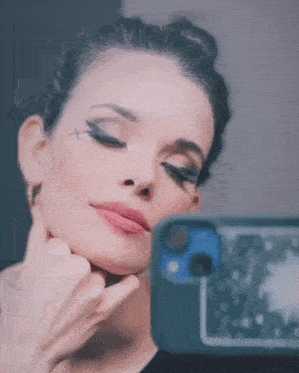 a woman taking a picture of herself in the mirror
