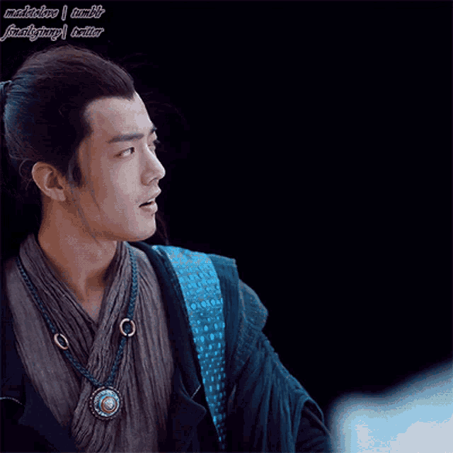 a man with a ponytail and a necklace with chinese writing on it
