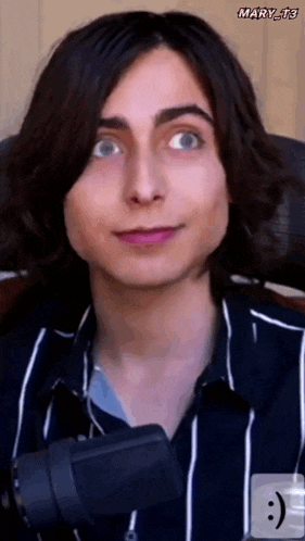 a close up of a person 's face with a microphone and a smiley face .