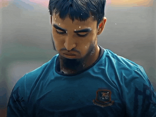 a man wearing a blue shirt with a tiger on the front