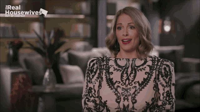 a woman in a black and white dress appears on a real housewives show