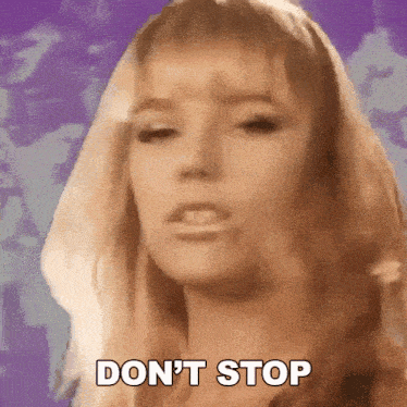 a woman is making a funny face and saying `` don 't stop '' .