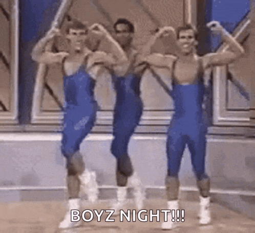 a group of men are standing next to each other and flexing their muscles in a gym .