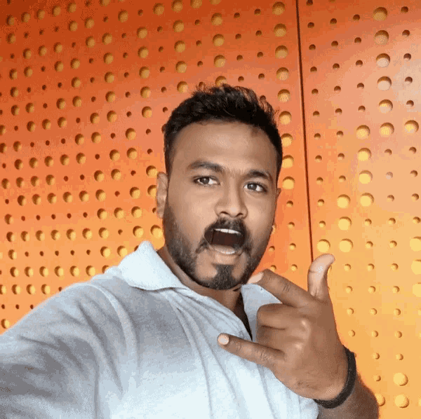 a man with a beard is giving a thumbs up