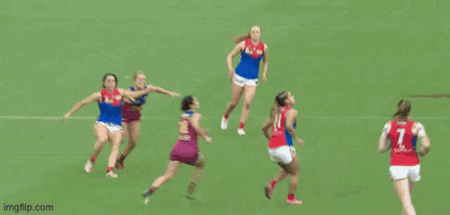a group of women are playing a game of soccer and one of the players has the number 2 on her back