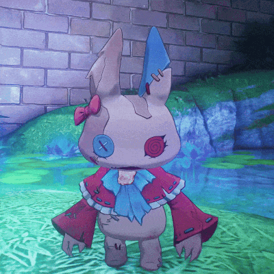 a stuffed bunny with a bow and buttons on its face is standing in front of a brick wall