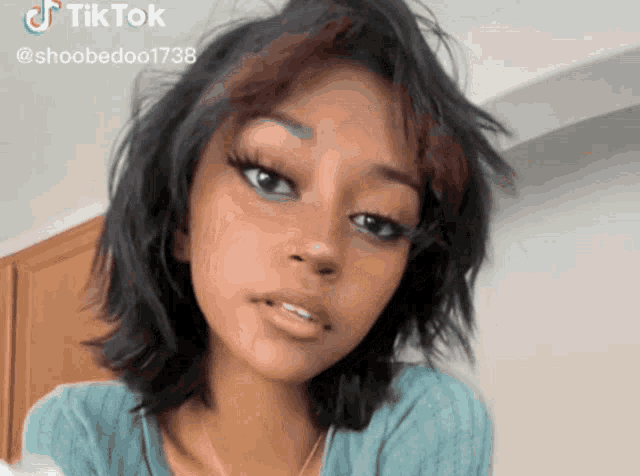 a close up of a woman 's face with a tiktok watermark on it