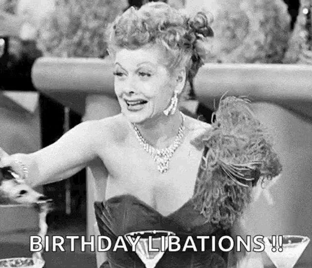 a black and white photo of a woman in a dress holding a martini and saying birthday libations .