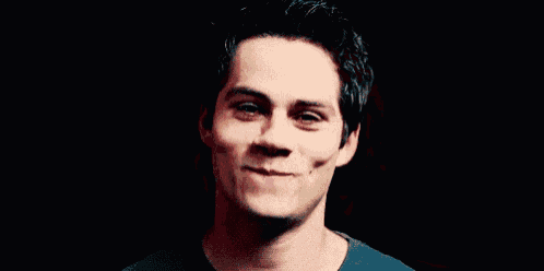 a close up of a man 's face with a slight smile on his face .