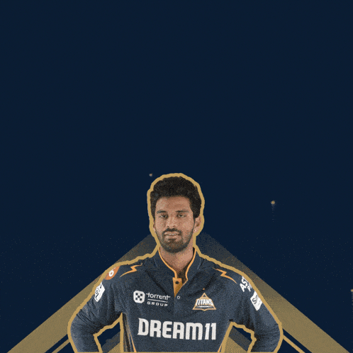 a man wearing a shirt that says dream11 waves his hands