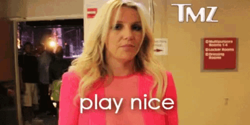 a blonde woman in a pink shirt says play nice