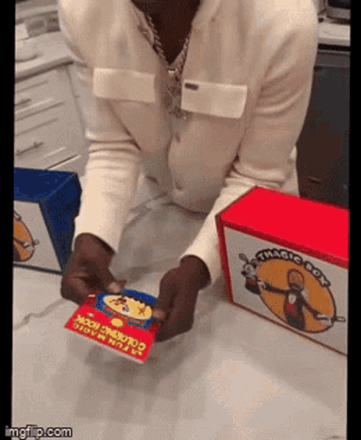 a man is holding a card that says a few magic tricks on it