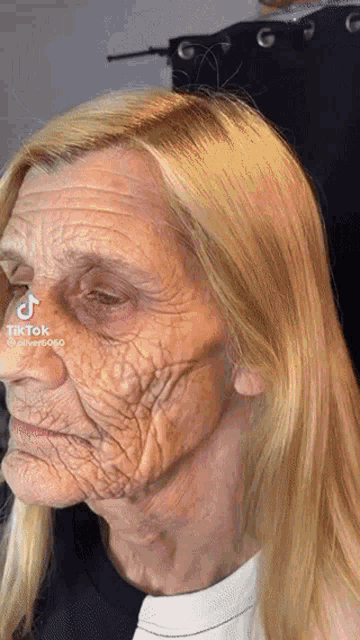 a close up of an older woman 's face with a tiktok sticker