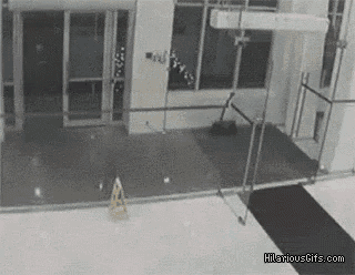 a black and white photo of a building with a wet floor .