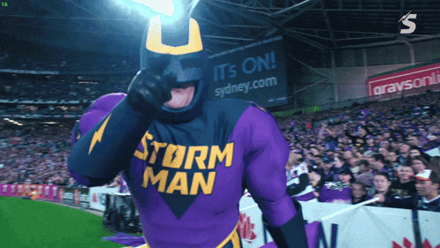 a man in a storm man costume is giving the thumbs up