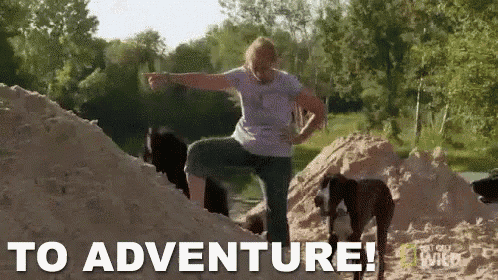 a woman is standing on top of a pile of sand next to two dogs and the words to adventure are visible .