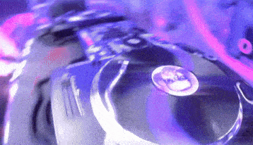 a close up of a dj 's turntable with purple lights in the background