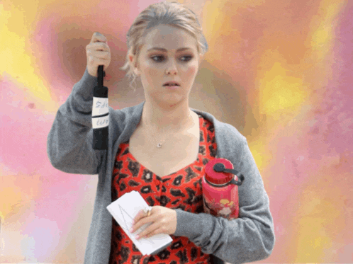 a woman holding a bottle of wine and a water bottle with the number 2 on the label