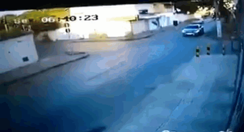 a car is driving down a street with a time stamp of 00 10 23