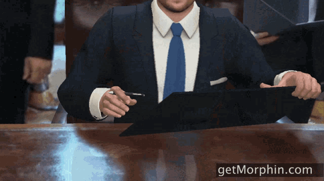 a man in a suit and tie is signing a document with a pen