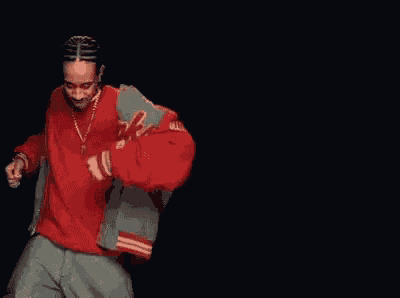 three men in red sweaters and grey pants are dancing in a row on a black background .