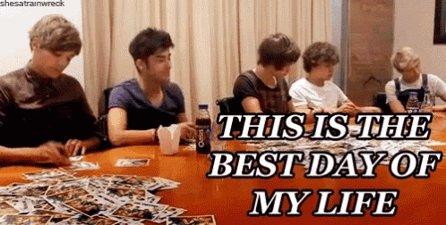a group of young men are sitting around a table with the caption " this is the best day of my life " on the bottom