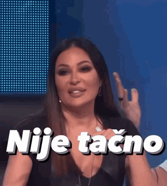 a woman is making a funny face and the words nije tacno are on the screen