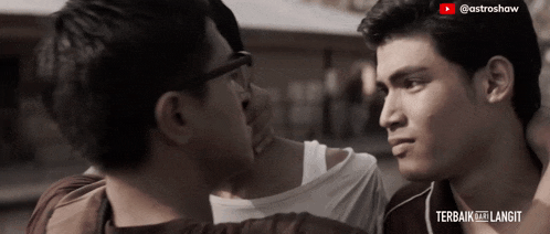 two men are looking at each other in a video that says " terbaik ke langit "