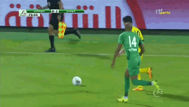 a soccer player with the number 14 on the back of his shirt