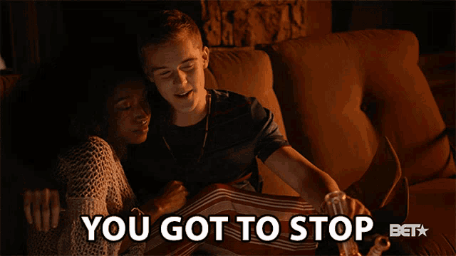 a man and woman sitting on a couch with the words " you got to stop " below them