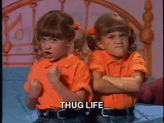 two little girls are sitting next to each other with their arms crossed and the words thug life written on the bottom
