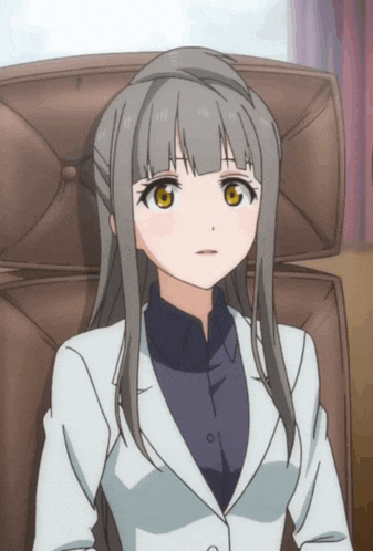 a girl with long hair and a white jacket is sitting in a brown chair