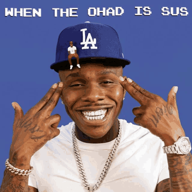 a man wearing a la hat with a tiny man sitting on it