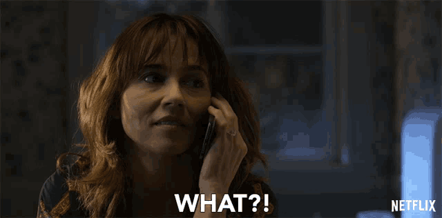 a woman talking on a cell phone with the words what on the bottom right