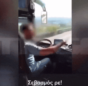 a man is driving a bus with a foreign language written on the bottom right corner