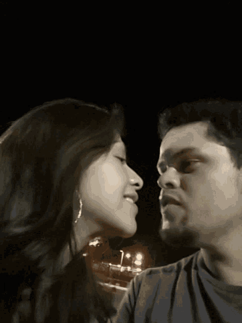 a man and a woman are looking into each others eyes