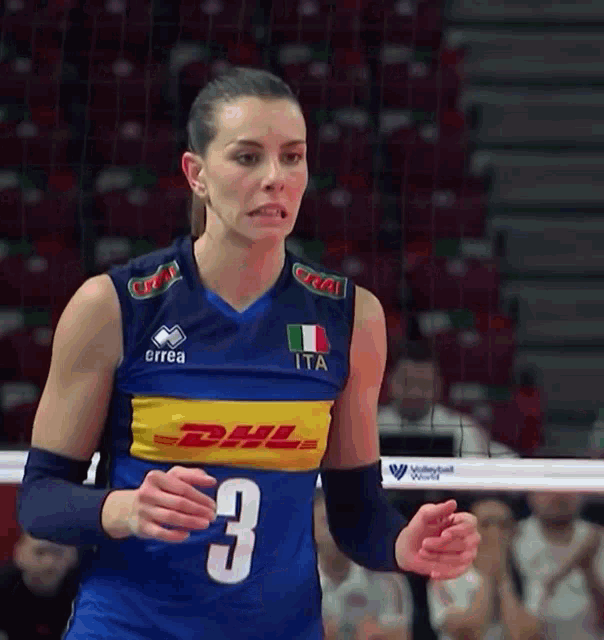 a female volleyball player wearing a blue jersey with the number 3